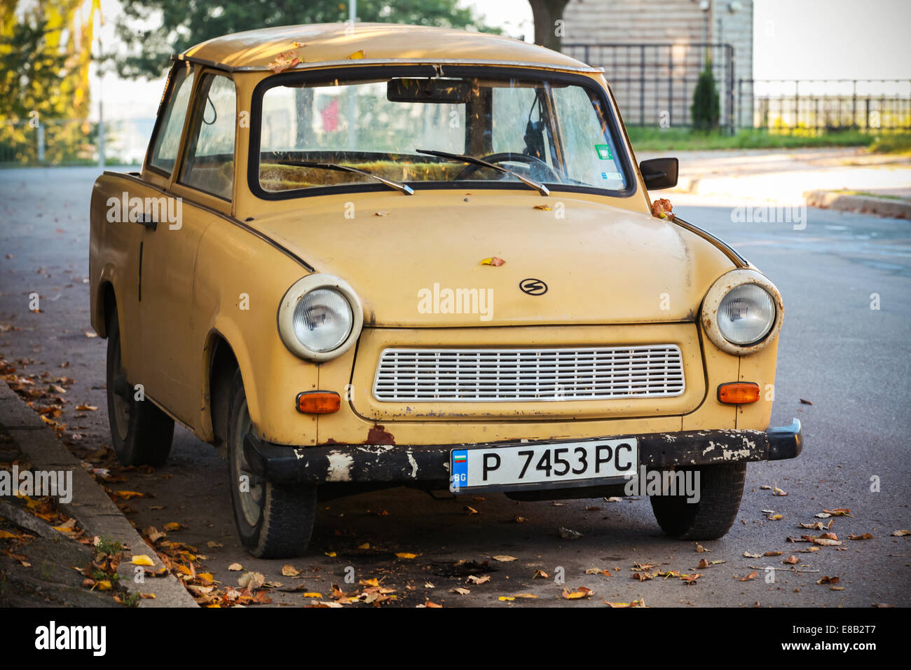 RUSE, BULGARIA - SEPTEMBER 29, 2014: Old yellow Trabant 601s car stands parked on a street side Stock Photo