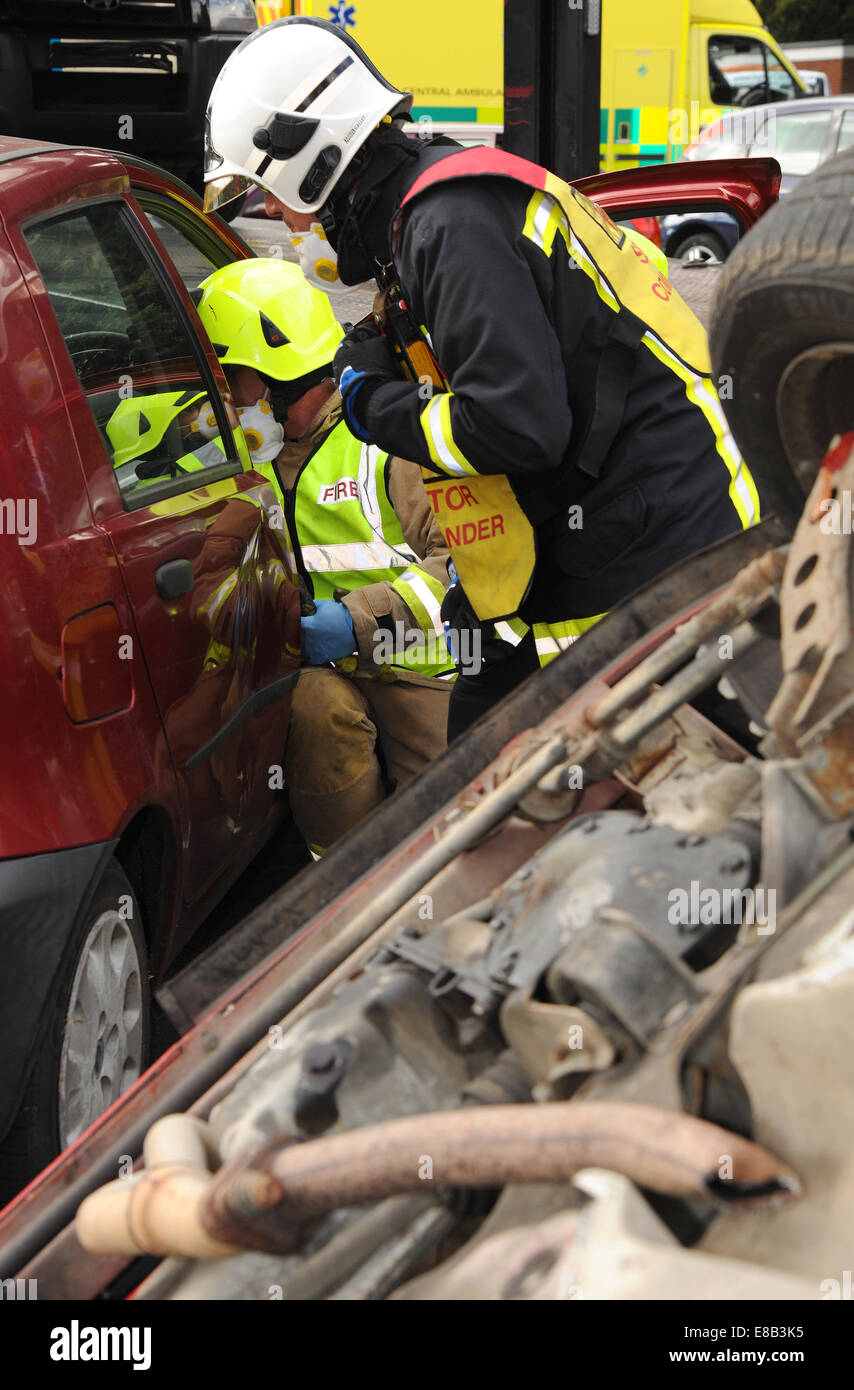Fire officers at car crash Stock Photo