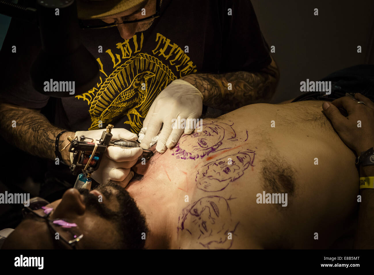 Oct. 3, 2014 - Tattoo artist EL FLACO, Ibiza, Spain, works on a man's chest tattoo at the 17th International Barcelona Tattoo Expo. © Matthias Oesterle/ZUMA Wire/ZUMAPRESS.com/Alamy Live News Stock Photo