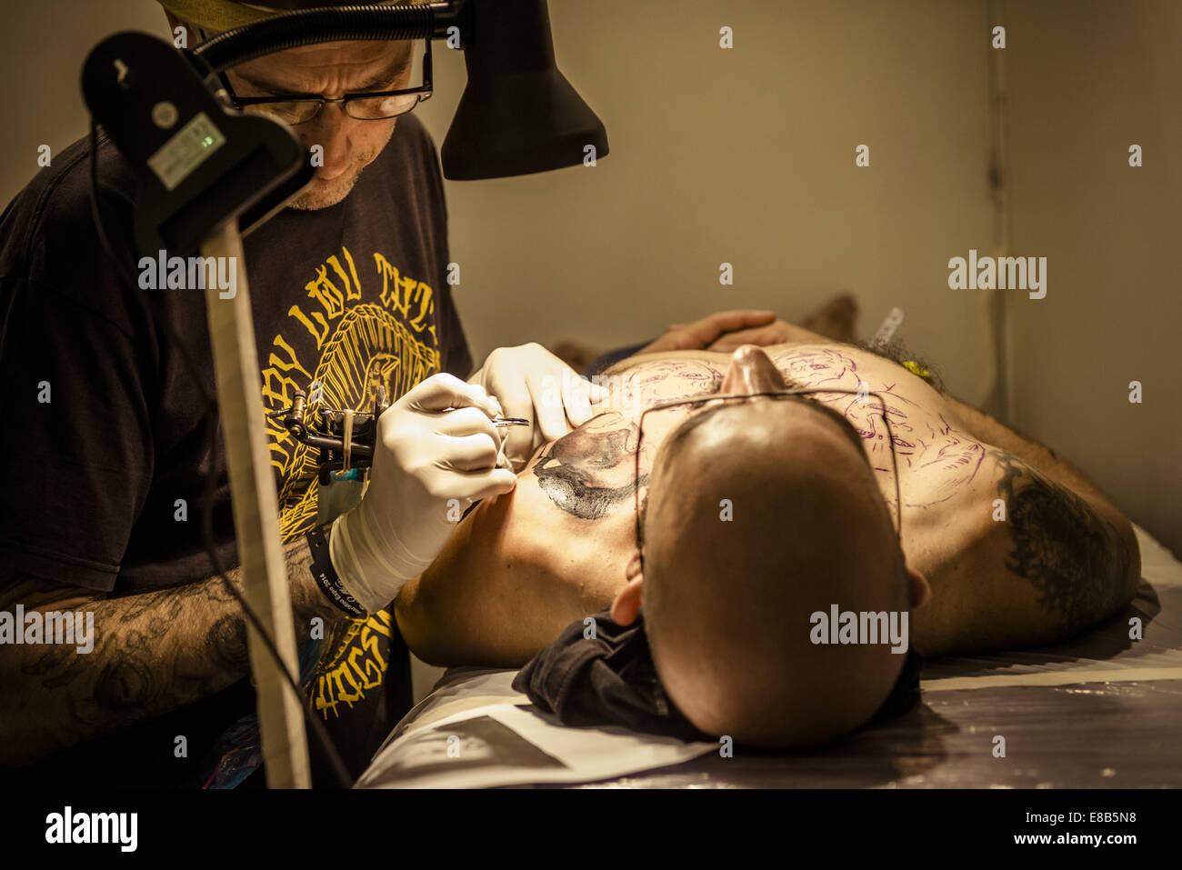 Oct. 3, 2014 - Tattoo artist EL FLACO, Ibiza, Spain, works on a man's chest tattoo at the 17th International Barcelona Tattoo Expo. © Matthias Oesterle/ZUMA Wire/ZUMAPRESS.com/Alamy Live News Stock Photo