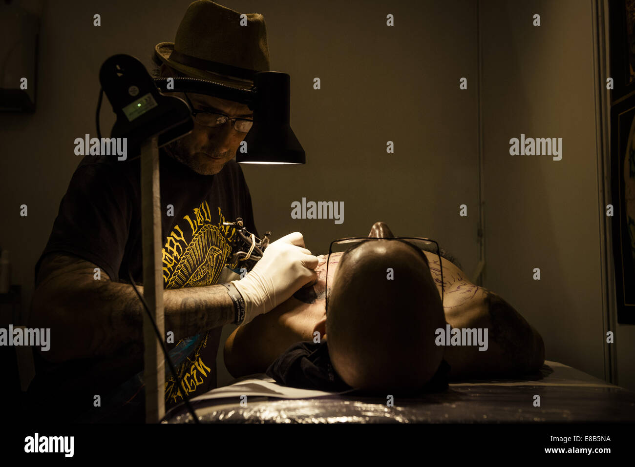 Oct. 3, 2014 - Tattoo artist EL FLACO, Ibiza, Spain, works on a man's chest tattoo at the 17th International Barcelona Tattoo Expo. © Matthias Oesterle/ZUMA Wire/ZUMAPRESS.com/Alamy Live News Stock Photo