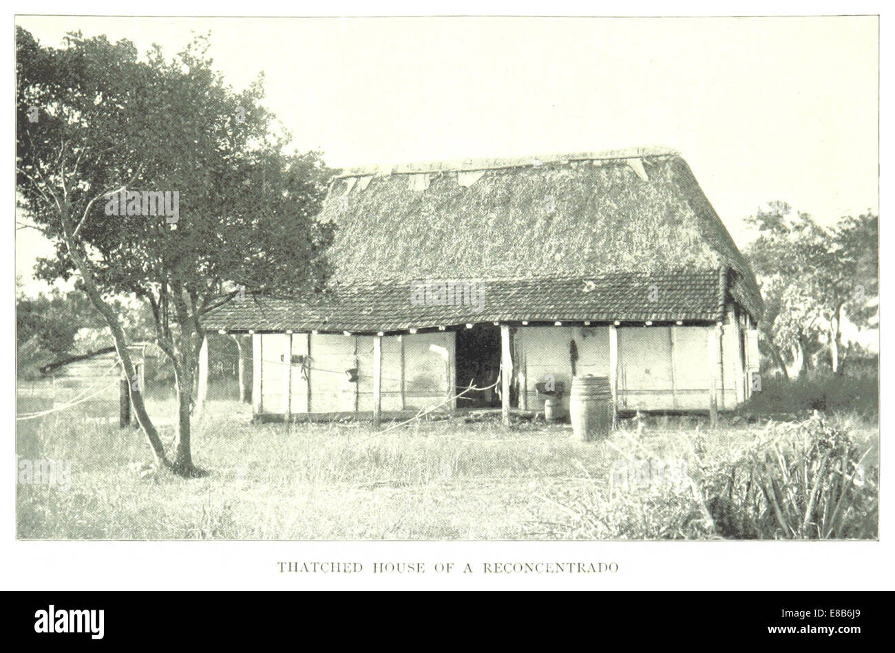 This 1899 illustration depicts a thatched house of a reconcentrado in Cuba, likely referencing a rural or displaced population during the Cuban War of Independence. Stock Photo