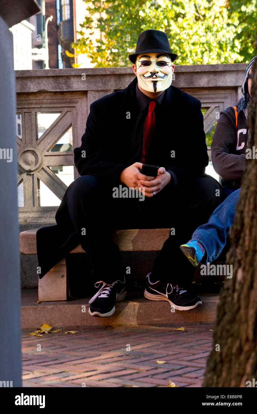 Protester wearing the Guy Fawkes mask of the Anonymous movement from the V character in the film V for Vendetta. Boston, Mass. Stock Photo