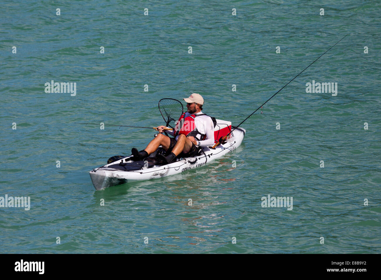 https://c8.alamy.com/comp/E8B9Y2/man-fishing-from-ocean-kayak-E8B9Y2.jpg