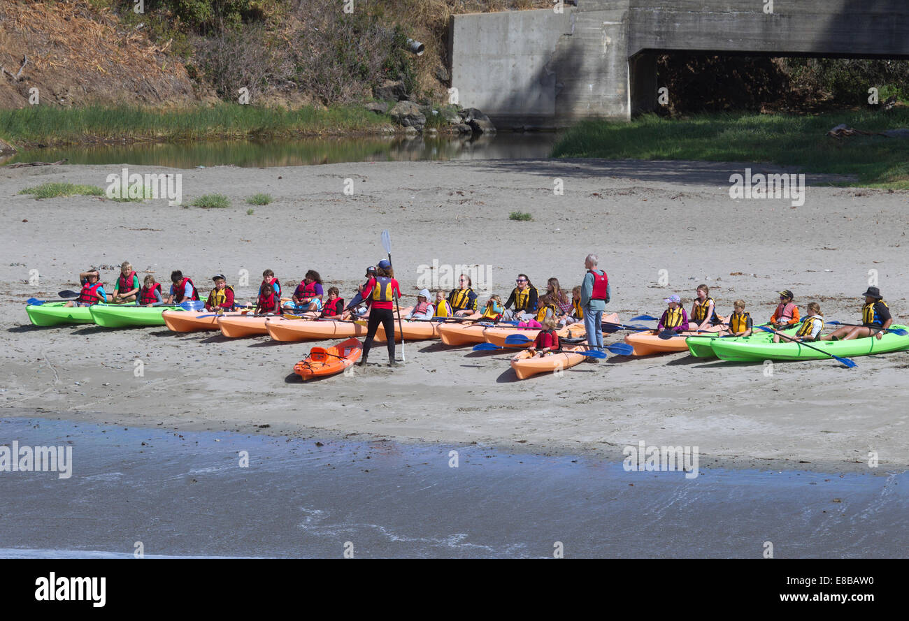 Kayaks lined up on the beach at start of a Kayaking class Stock Photo