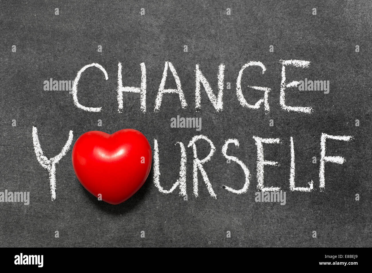 change yourself phrase handwritten on blackboard with heart symbol instead of O Stock Photo