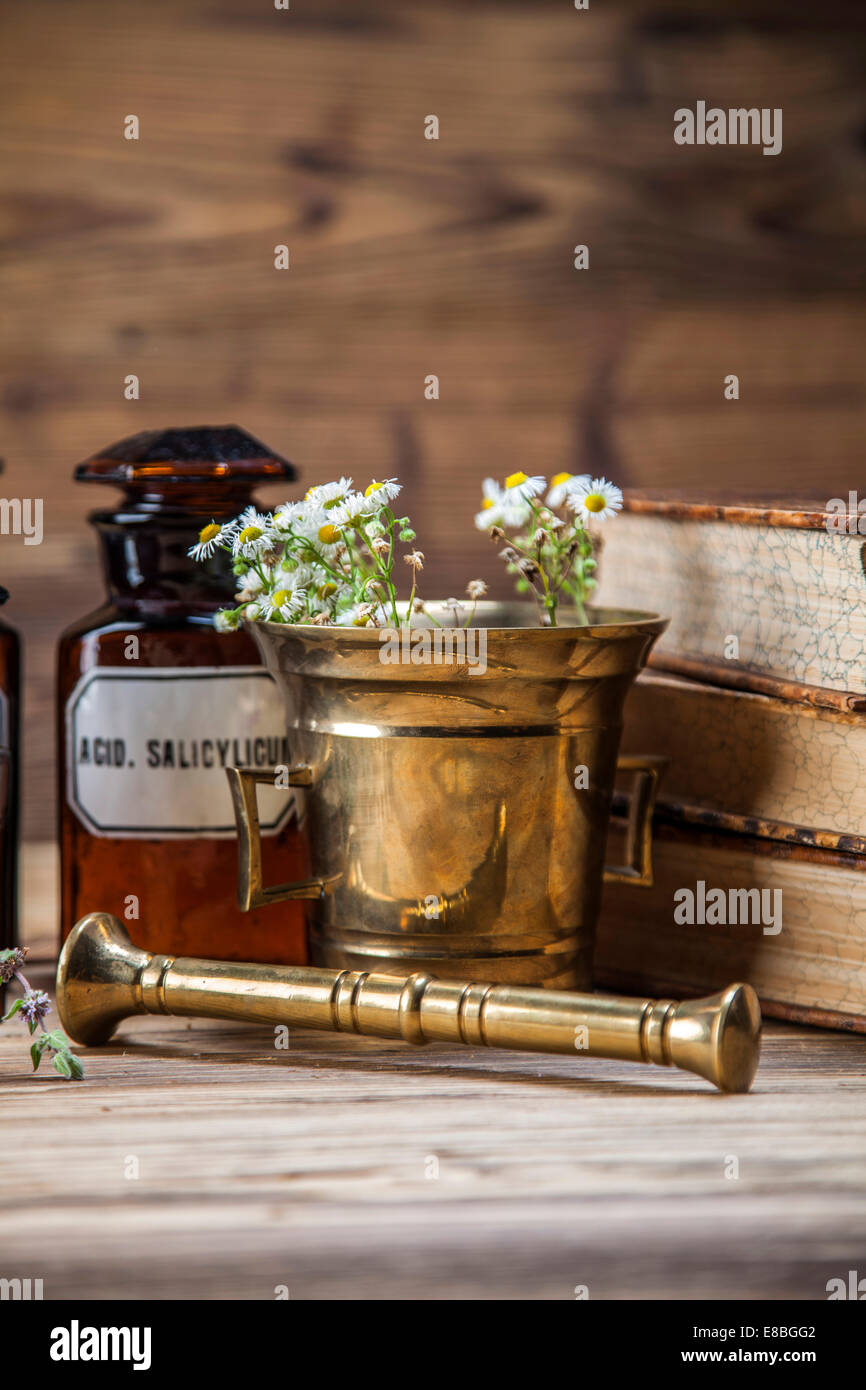 The ancient natural medicine, herbs, medicines and old book Stock Photo