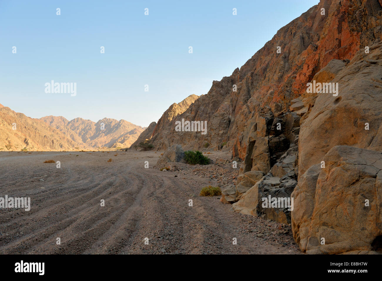 Dirt vehicle tracks between mountains across desert in south Sinai Peninsula, Egypt Stock Photo
