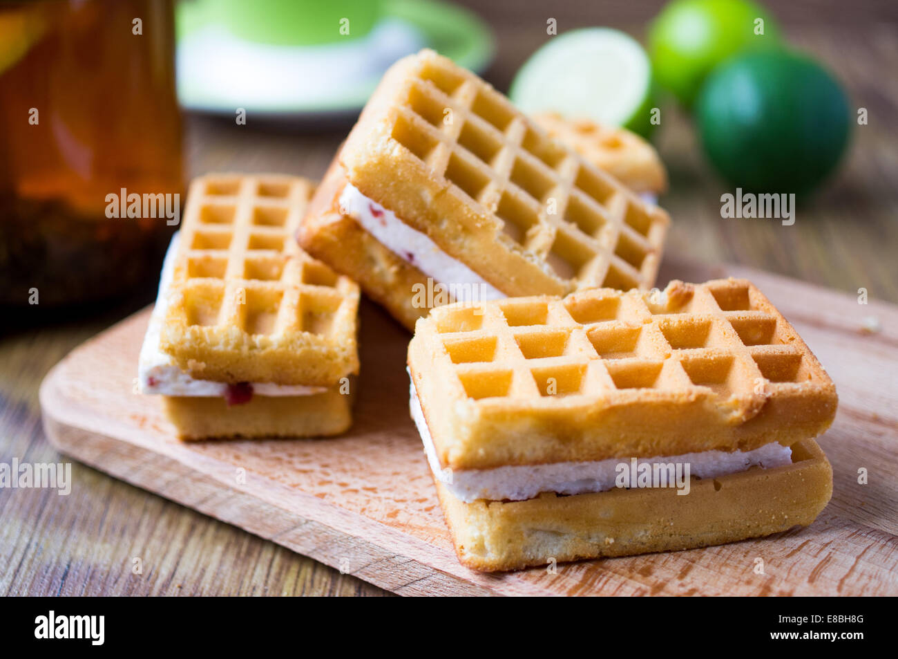 Waffles souffle stuffing. On the table lime and tea. Stock Photo