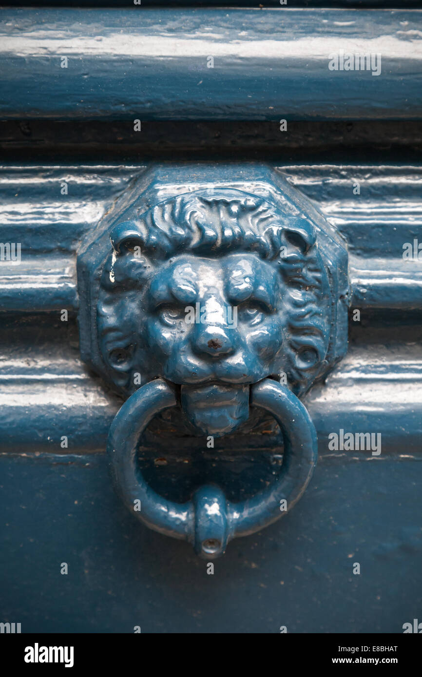 Old blue door knocker in shape of lion head Stock Photo