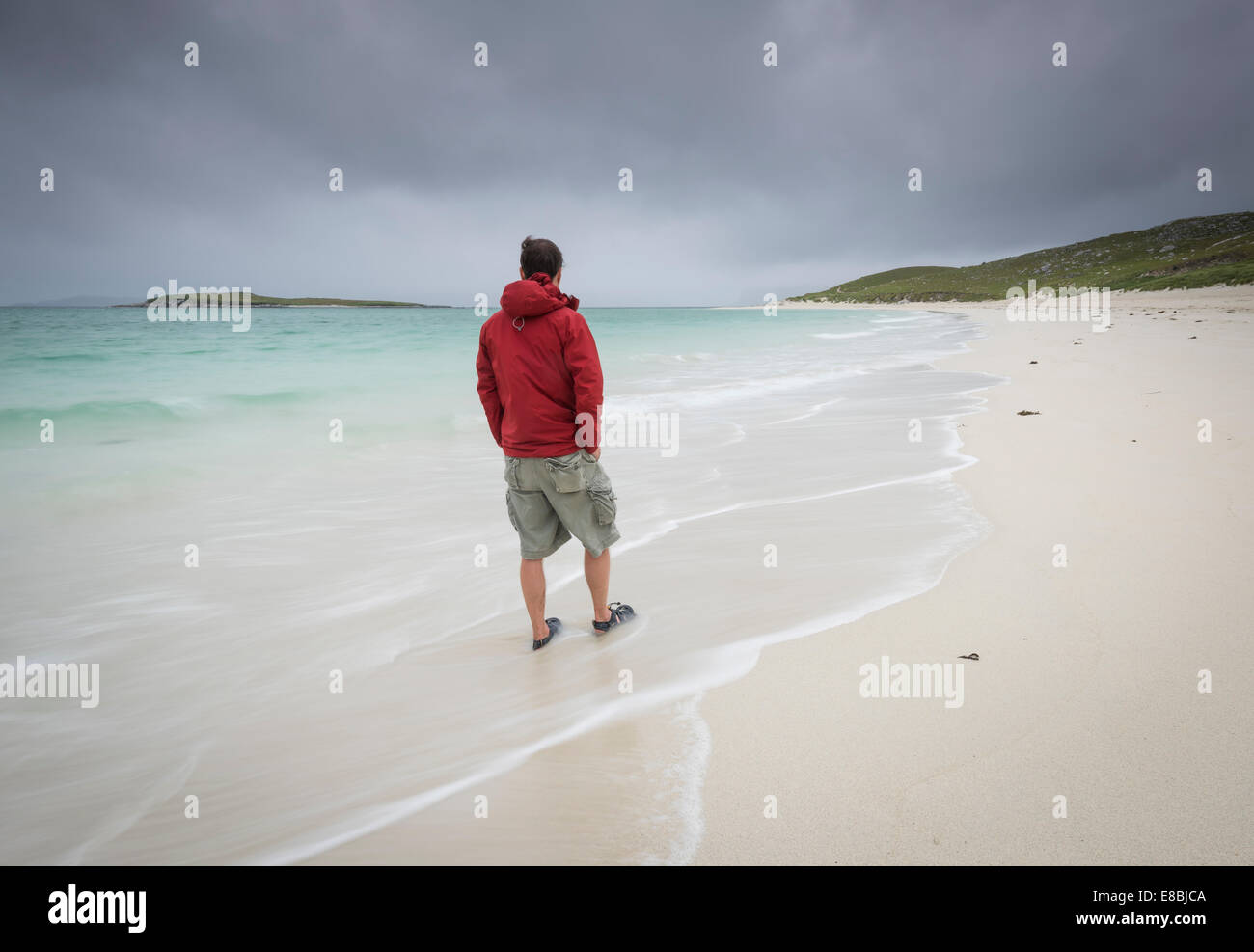 Figure in red on Traigh Mheilen beach, Isle of Harris, Outer Hebrides, Scotland Stock Photo