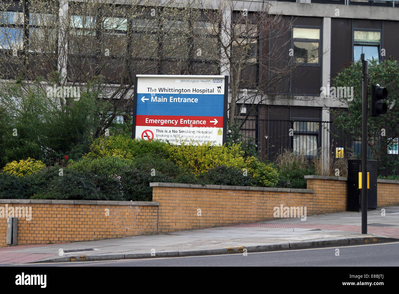 Sign pointing to the emergency and main entrances of The Whittington Hospital, in north London Stock Photo