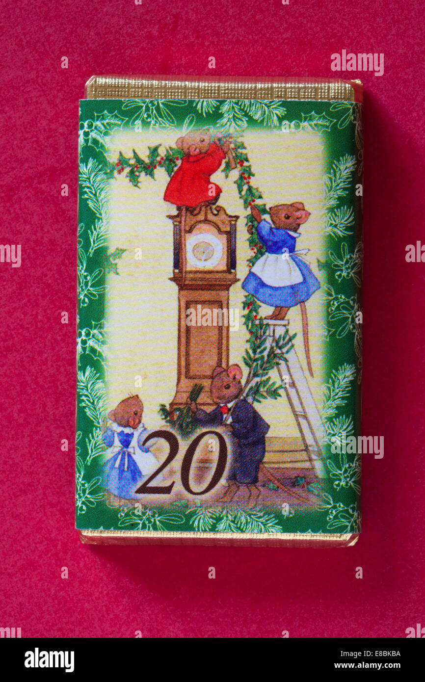 Count down to Christmas with individual advent chocolate bars isolated on red background - calendar day 20 of set of 24 Stock Photo
