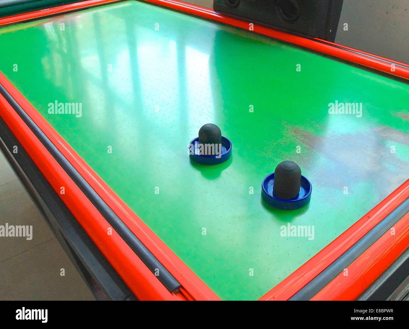 Air hockey table closeup with paddle at amusement arcade Stock Photo