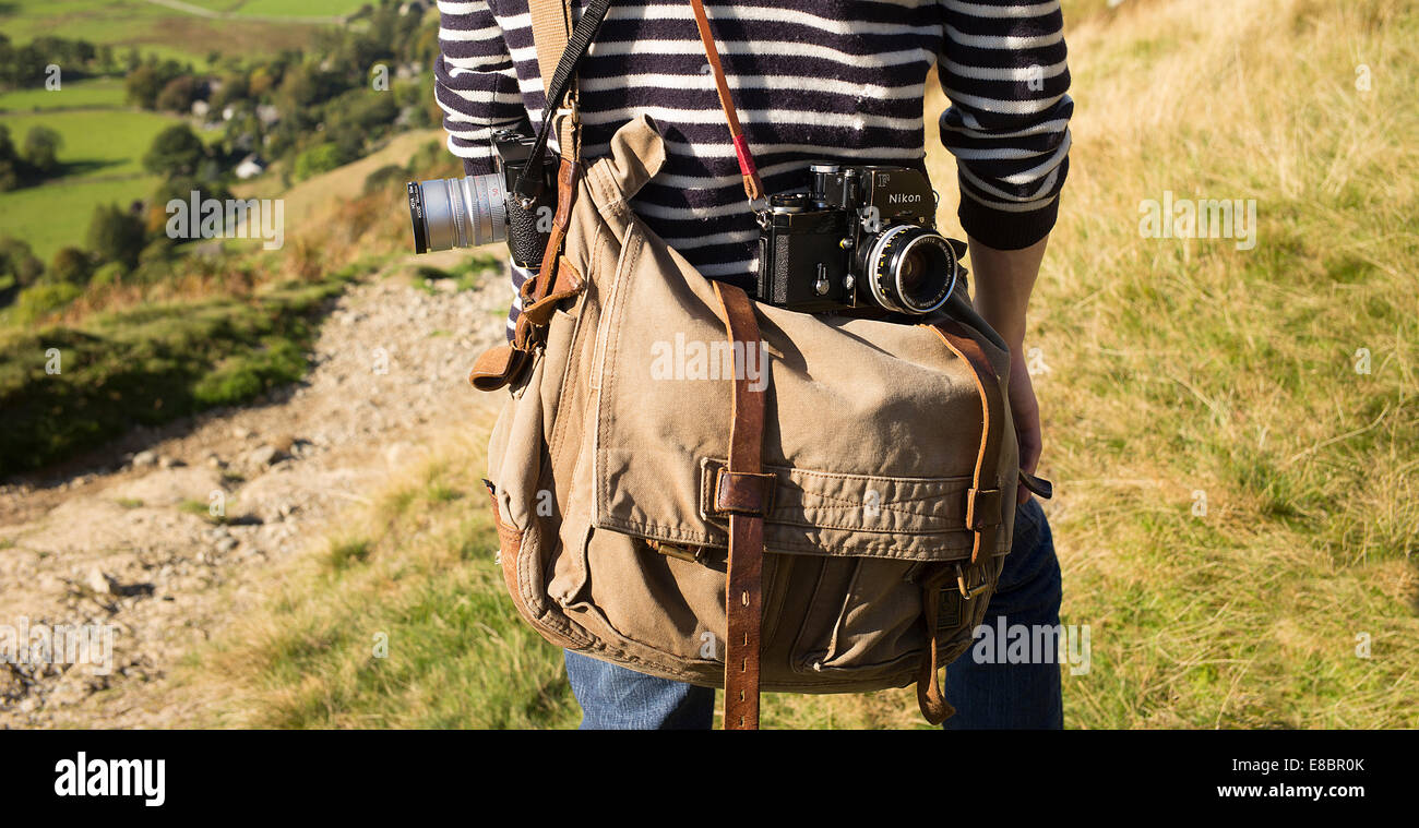 Photographers gadget bag and classic film cameras out on location. Stock Photo