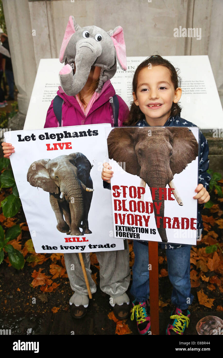 London, UK. 4th October 2014. Marchers with placards and banners at the Global March for Elephants and Rhinos, London, England. Rain didn't dampen the spirits of the marchers raising awareness of the plight of elephants and rhinos which amongst other things are being killed by poachers for ivory and souvenirs. Credit:  Paul Brown/Alamy Live News Stock Photo