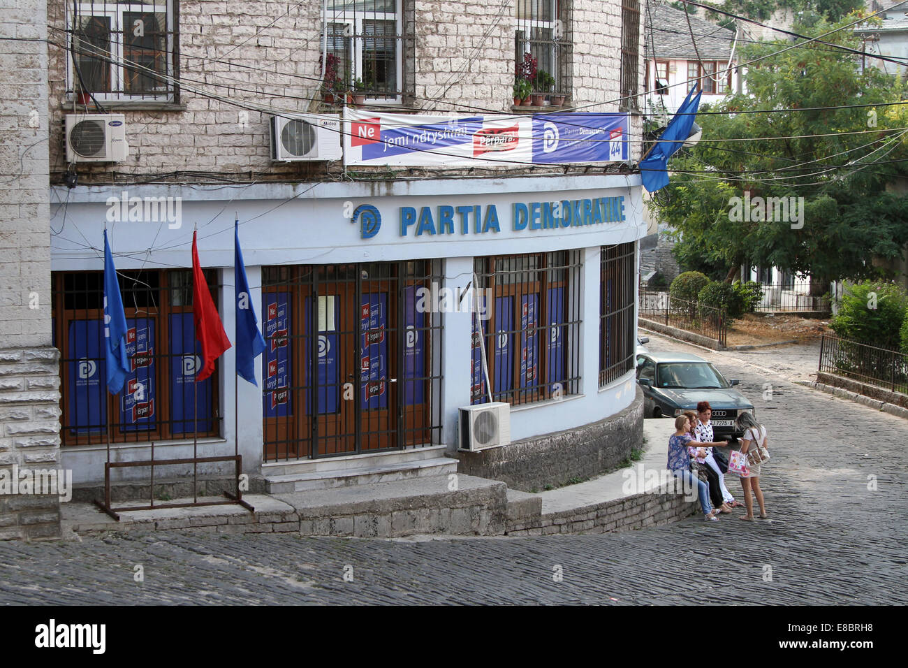 Locals chat outside the offices of the Democratic Party in Gjirokastra, Albania Stock Photo