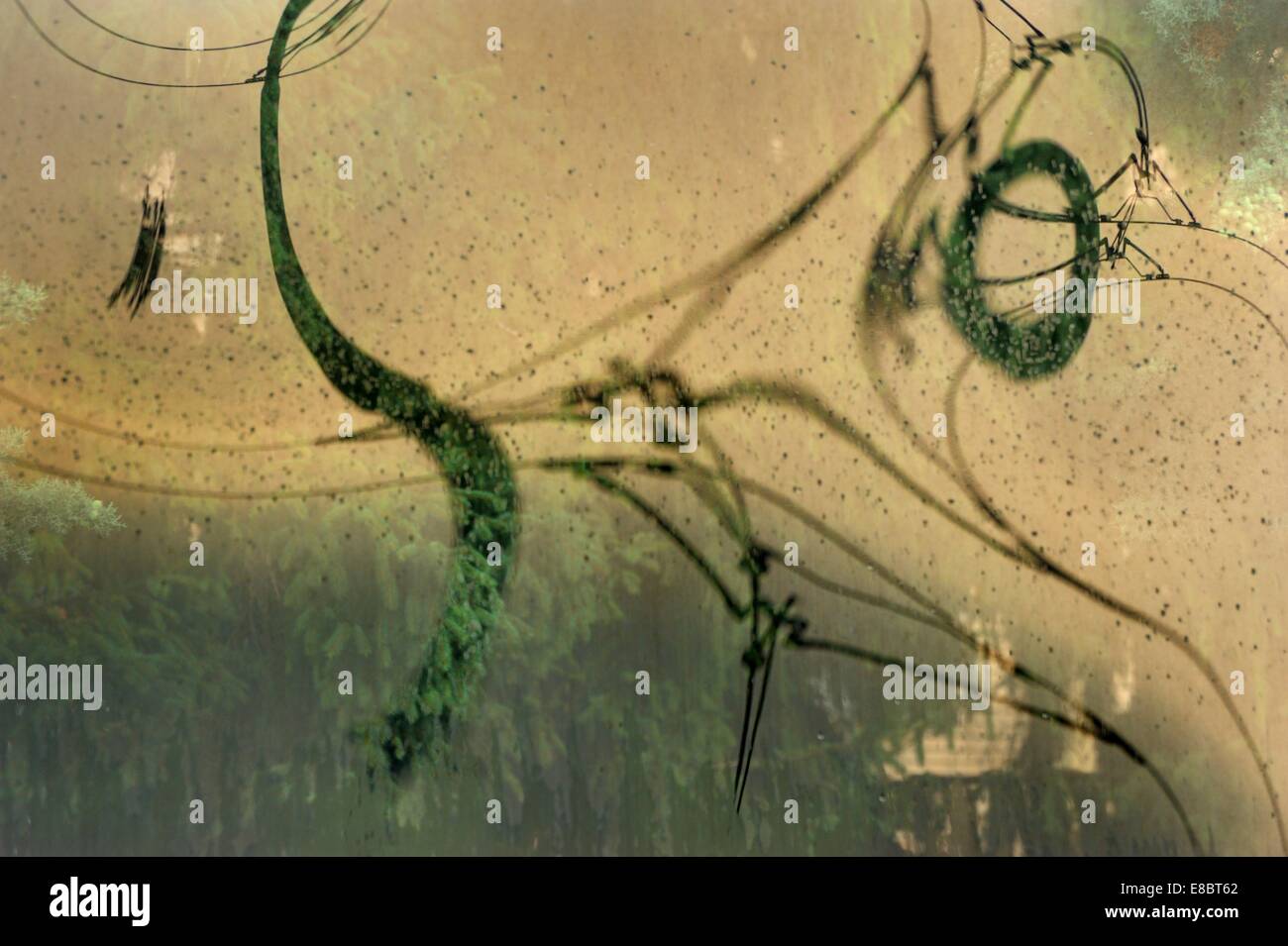 Abstract sinuous lines of an electric train line on a plexiglass,(polymethylmethacrylate) Stock Photo