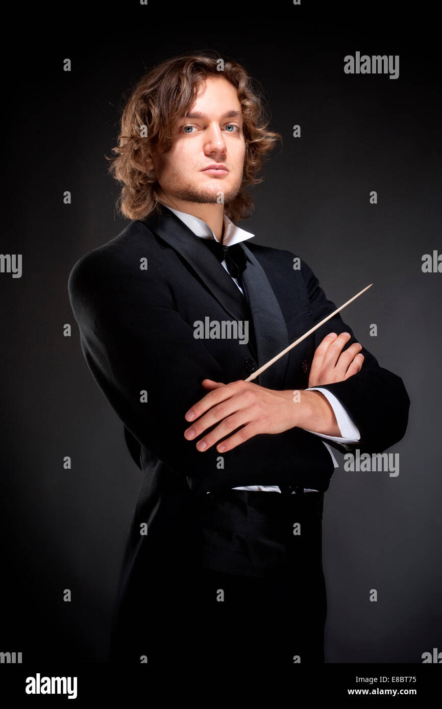 Portrait of a Young Conductor Holding a  Baton. Stock Photo