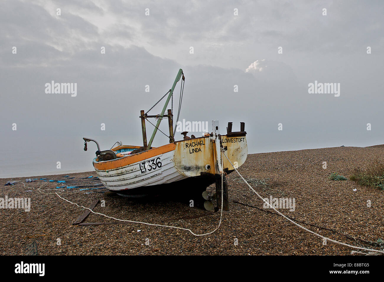 fishing boat on shingle beach Stock Photo - Alamy