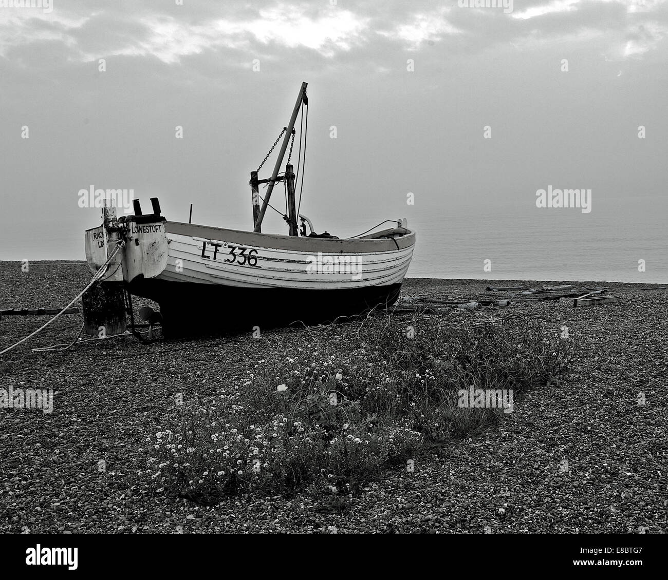 fishing boat on shingle beach Stock Photo - Alamy