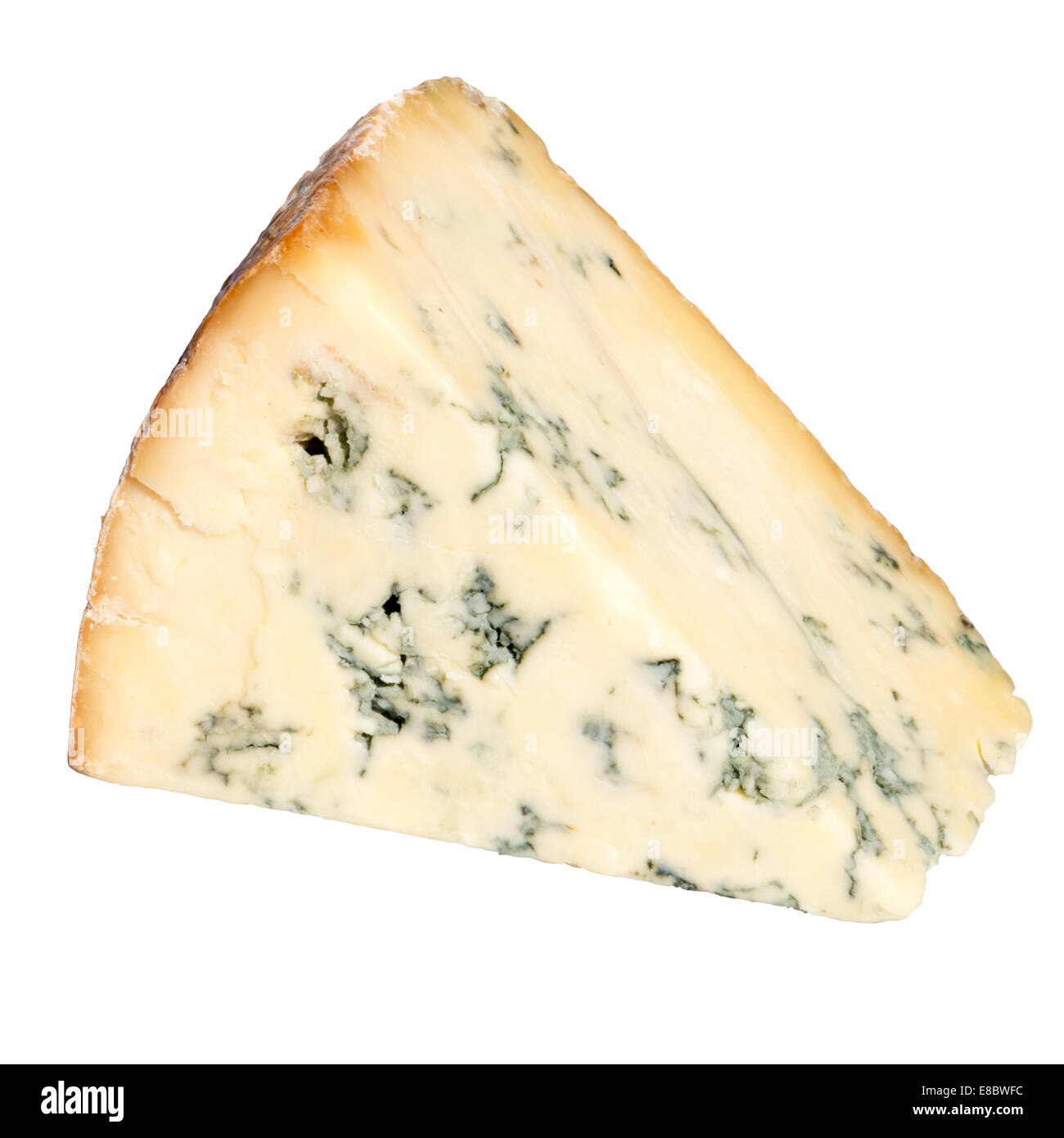 Wedge of blue Stilton cheese cut out or isolated on a white background. Stock Photo