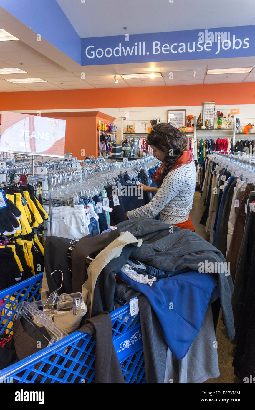 young woman clothes shopping at Goodwill store, Seattle, USA Stock Photo