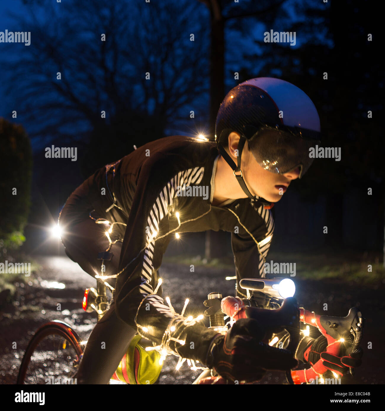 Christmas Tree Cyclist with LED lighting at night. Stock Photo