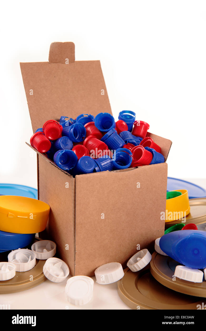 a paperboard box with a lot of caps for recycle on a white background