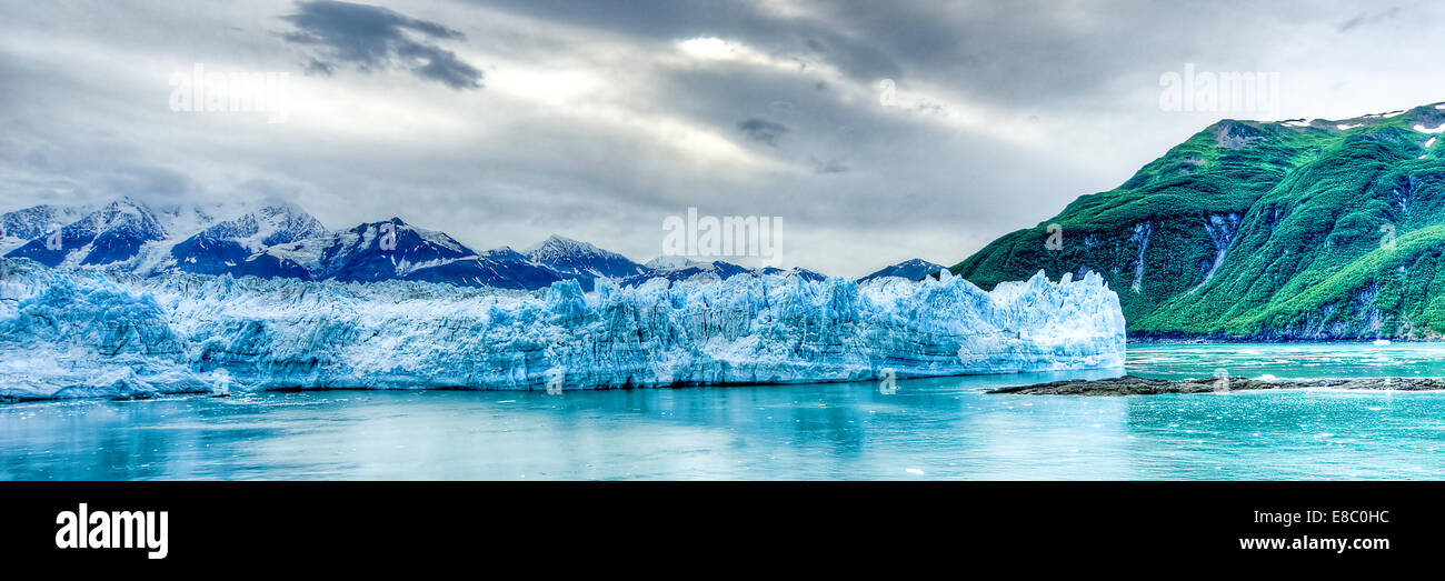 Landscape view of Hubbard glacier, purple mountains and emerald hills. Alaska's amazing environment / geography all in one shot Stock Photo