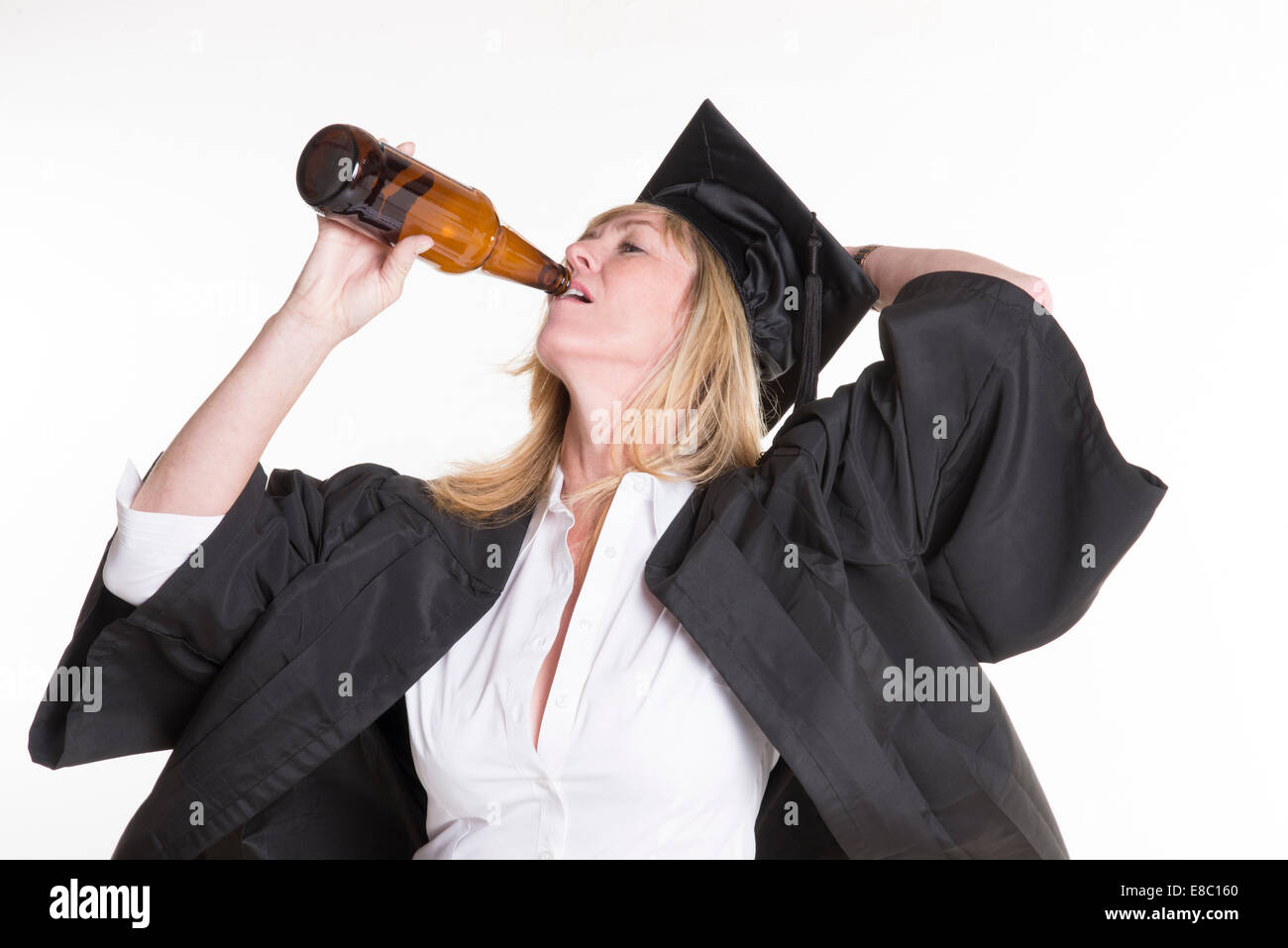 Mature university student drinking beer from a brown bottle Stock Photo