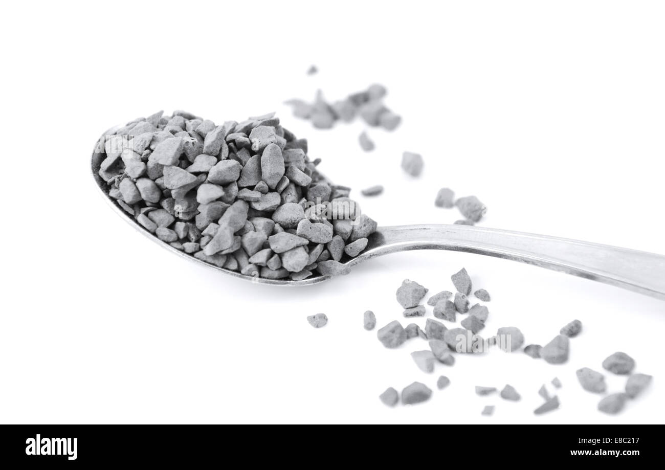 Close up of a teaspoon of instant coffee granules, isolated on a white ...