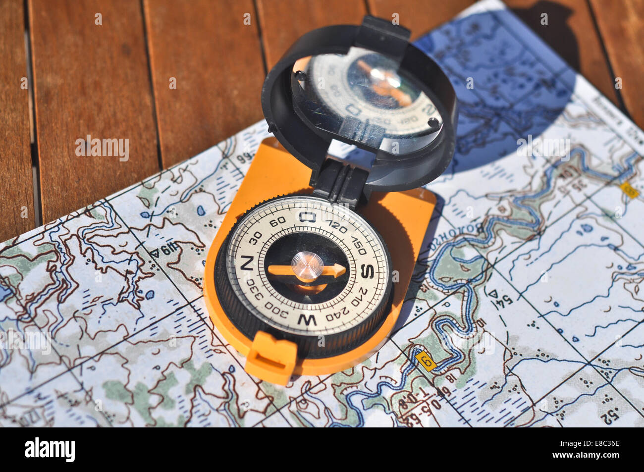 Compass, map. The magnetic compass is located on a topographic map ...