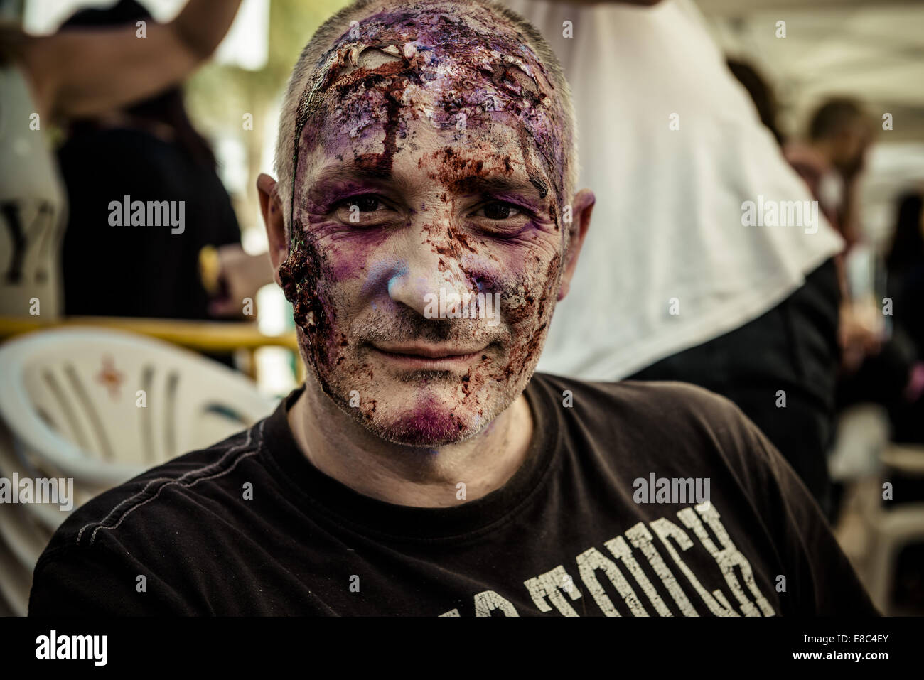 Sitges, Spain. 4th Oct, 2014. A man in zombie makeup looks at the camera as his face is ready for the Sitges Zombie Walk 2014 Credit:  Matthias Oesterle/ZUMA Wire/ZUMAPRESS.com/Alamy Live News Stock Photo