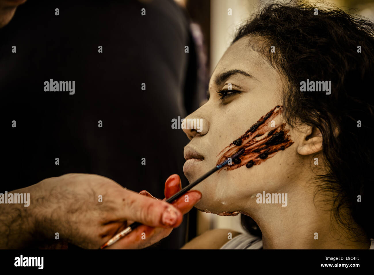 Sitges, Spain. 4th Oct, 2014. A makeup artist puts a zombie makeup on a girl's face for the Sitges Zombie Walk 2014 Credit:  Matthias Oesterle/ZUMA Wire/ZUMAPRESS.com/Alamy Live News Stock Photo