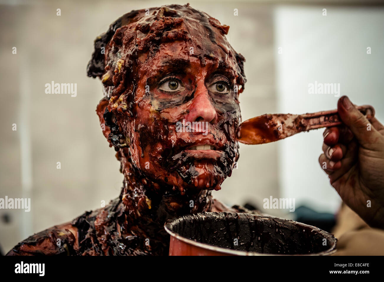 Sitges, Spain. 4th Oct, 2014. A makeup artist remodels the zombie makeup of a woman taking part in the Sitges Zombie Walk 2014 Credit:  Matthias Oesterle/ZUMA Wire/ZUMAPRESS.com/Alamy Live News Stock Photo