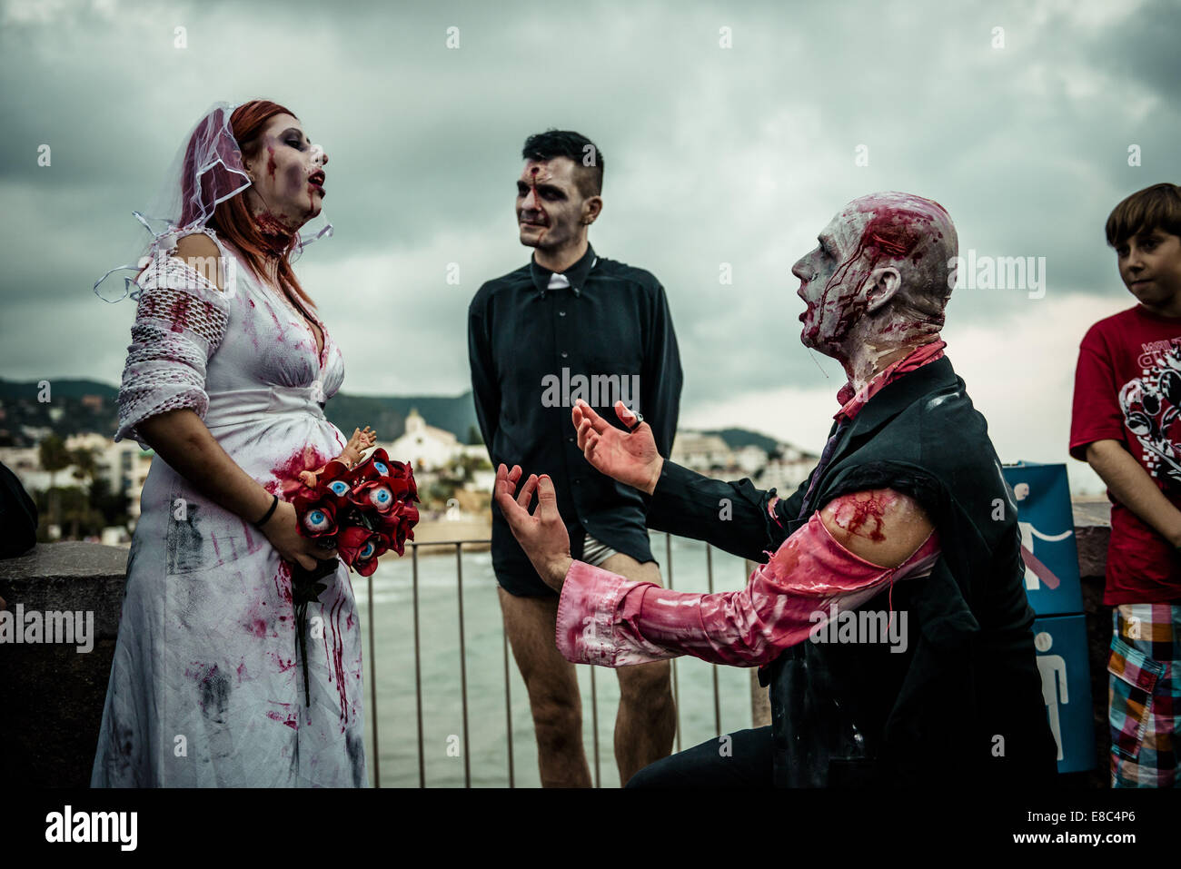 Sitges, Spain. 4th Oct, 2014. A zombie bridal couple and a zombie priest take part in the Sitges Zombie Walk 2014 Credit:  Matthias Oesterle/ZUMA Wire/ZUMAPRESS.com/Alamy Live News Stock Photo