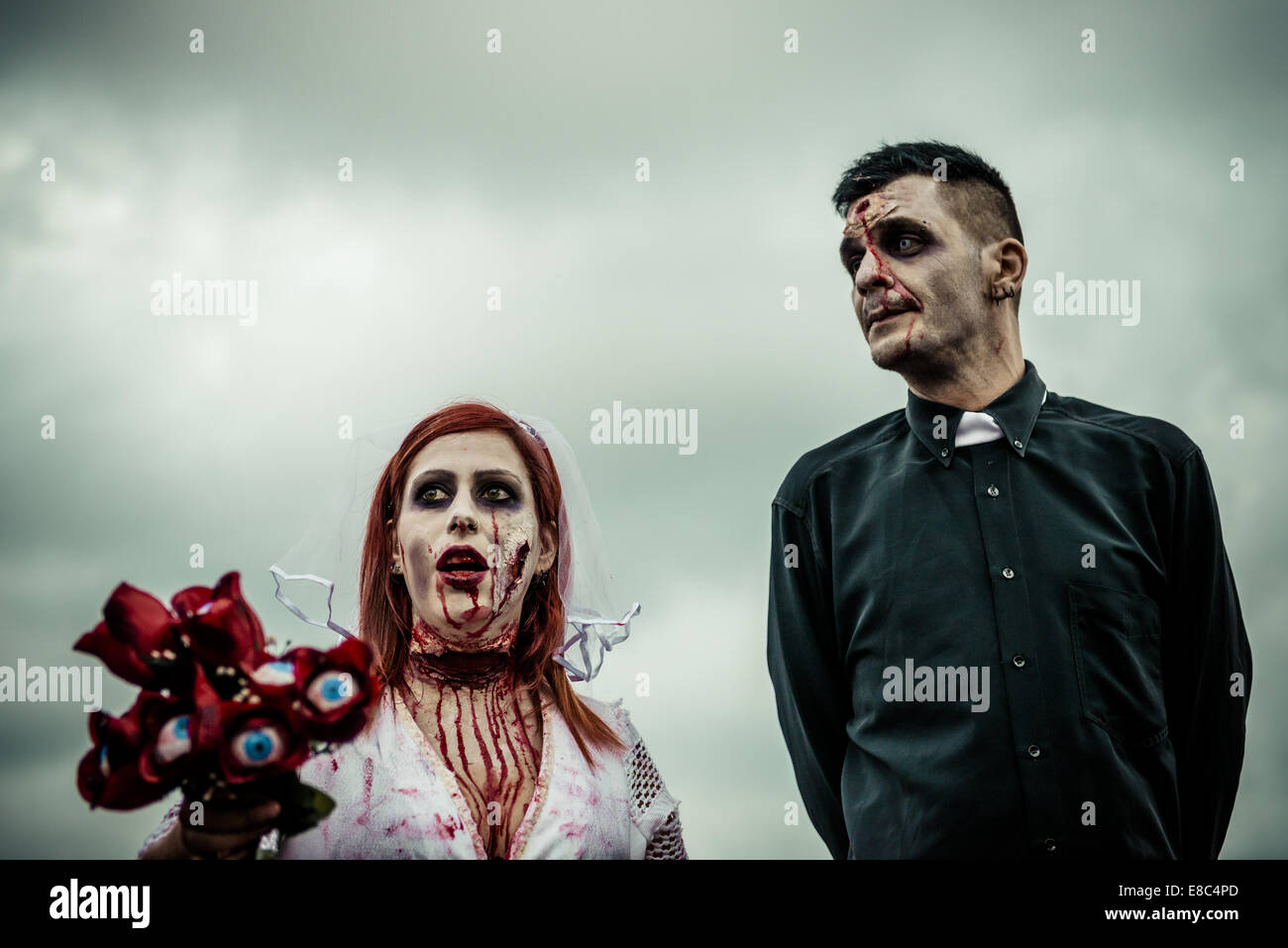 Sitges, Spain. 4th Oct, 2014. A zombie bride and a zombie priest take part in the Sitges Zombie Walk 2014 Credit:  Matthias Oesterle/ZUMA Wire/ZUMAPRESS.com/Alamy Live News Stock Photo