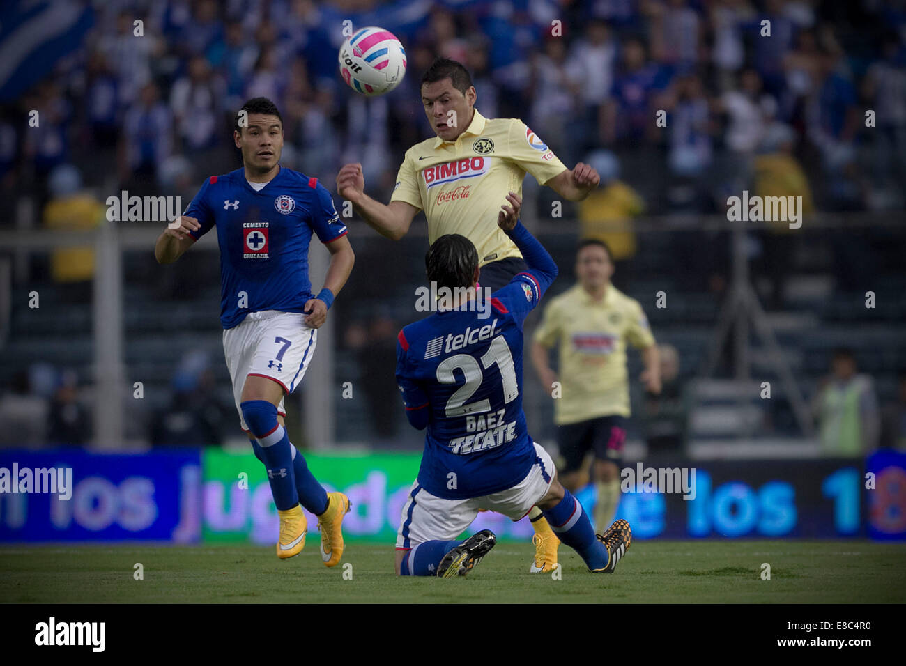 Mexico City, Mexico. 4th Oct, 2014. Pablo Barrera (L) and Xavier Baez (Bottom) of Cruz Azul vie for the ball with America's Pablo Aguilar (Top) during their match of the 2014 MX League Opening Tournament held at Azul Stadium in Mexico City, capital of Mexico, on Oct. 4, 2014. Credit:  Alejandro Ayala/Xinhua/Alamy Live News Stock Photo