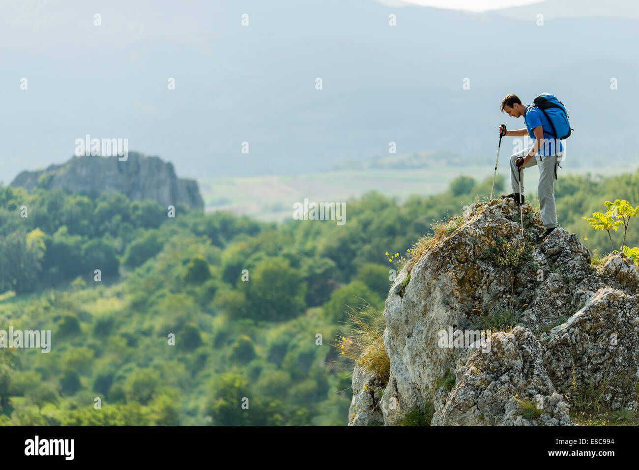 Young man hiking on the mountain Stock Photo - Alamy