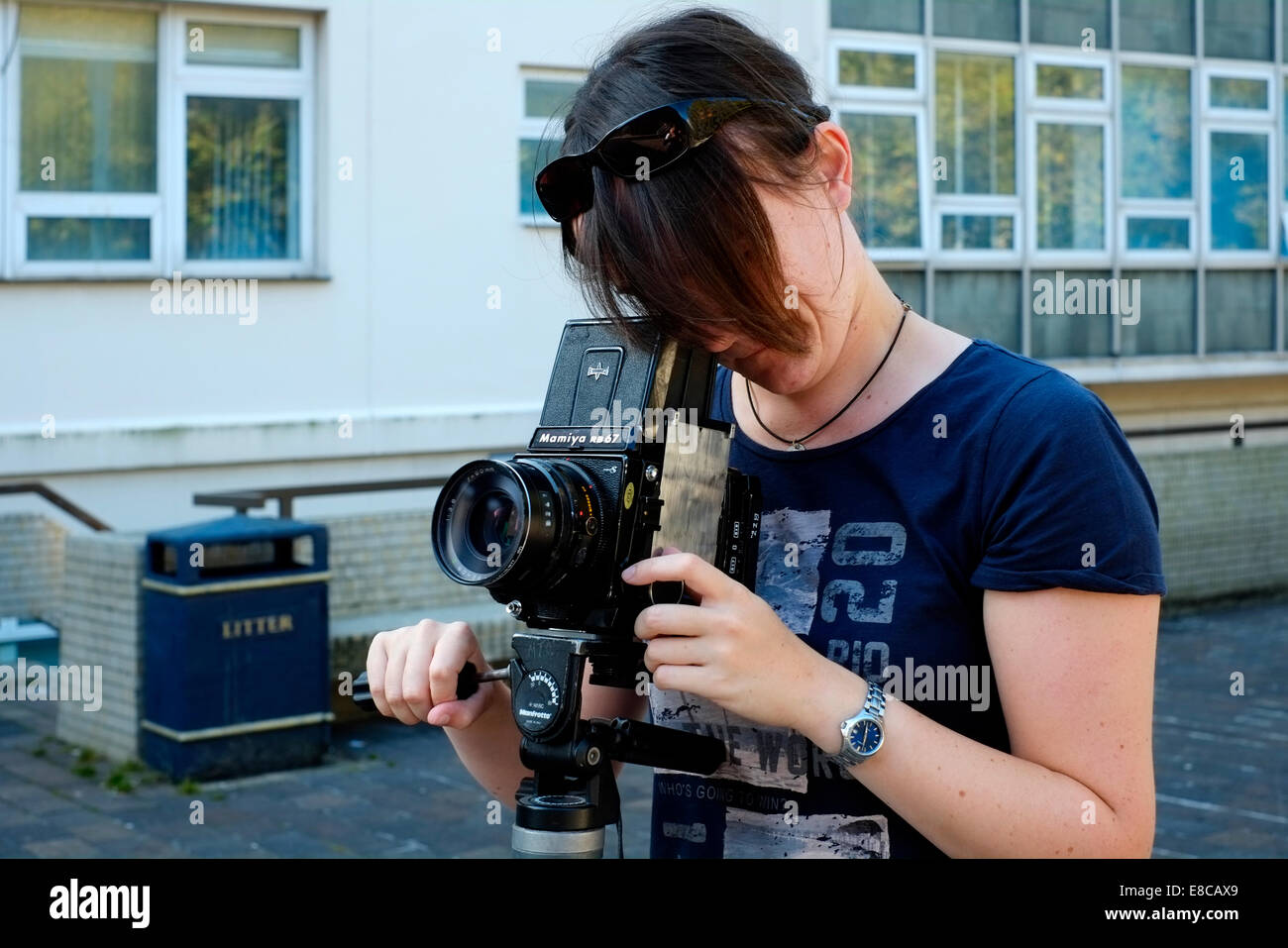 young female photography student learning to use a medium format roll