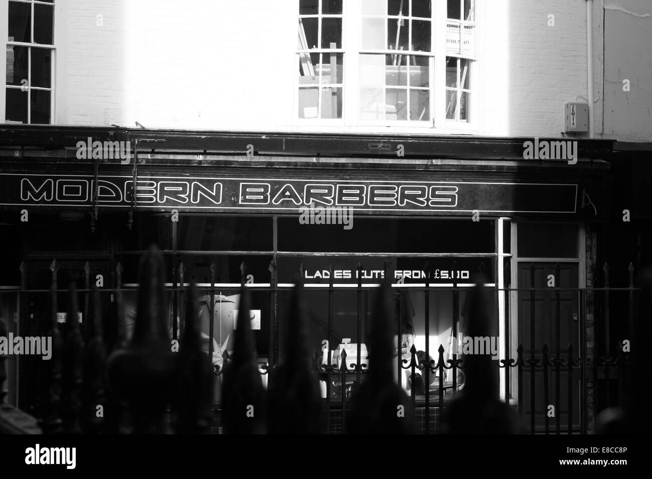 Barbers shop very early in the morning in St Mary's street,Weymouth,Dorset. Stock Photo