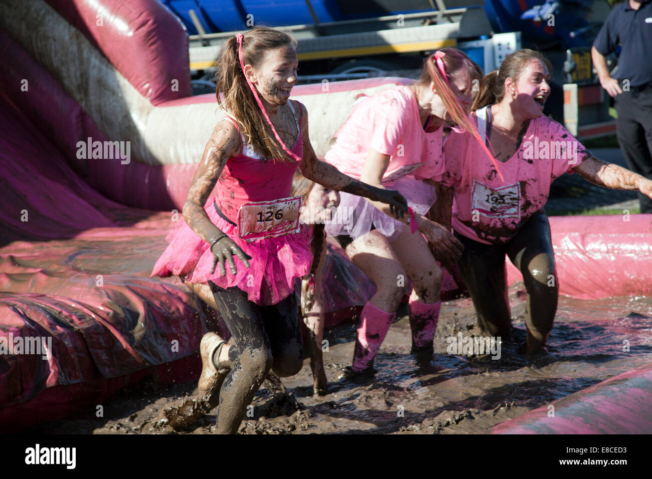 London, UK. 5th Oct, 2014. Cancer Race for Life Run - Participants down Mud Slide near Finish on Clapham Common, London UK Credit:  M.Sobreira/Alamy Live News Stock Photo