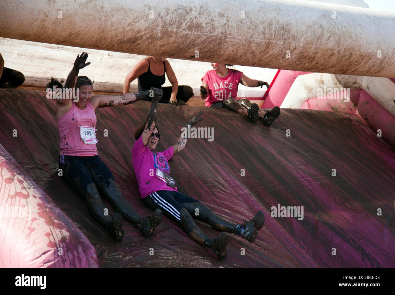 London, UK. 5th Oct, 2014. Cancer Race for Life Run - Participants down Mud Slide near Finish on Clapham Common, London UK Credit:  M.Sobreira/Alamy Live News Stock Photo