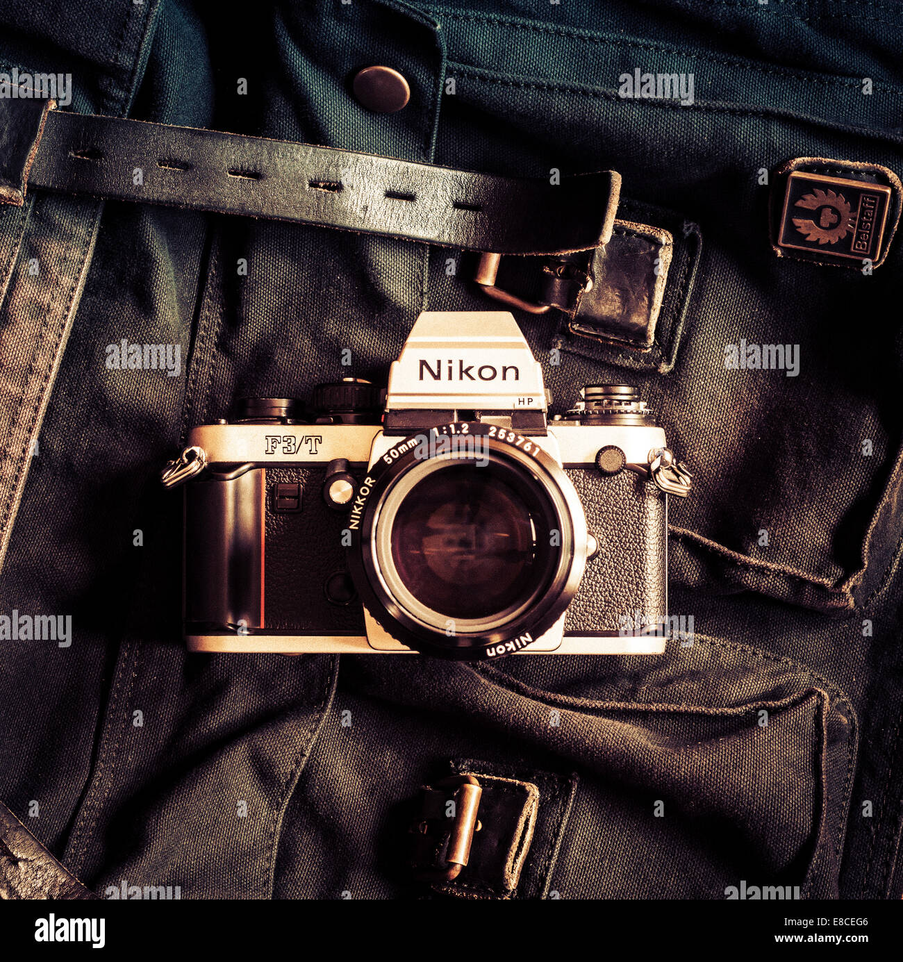 Nikon F3/T classic film camera with Belstaff bag. Stock Photo