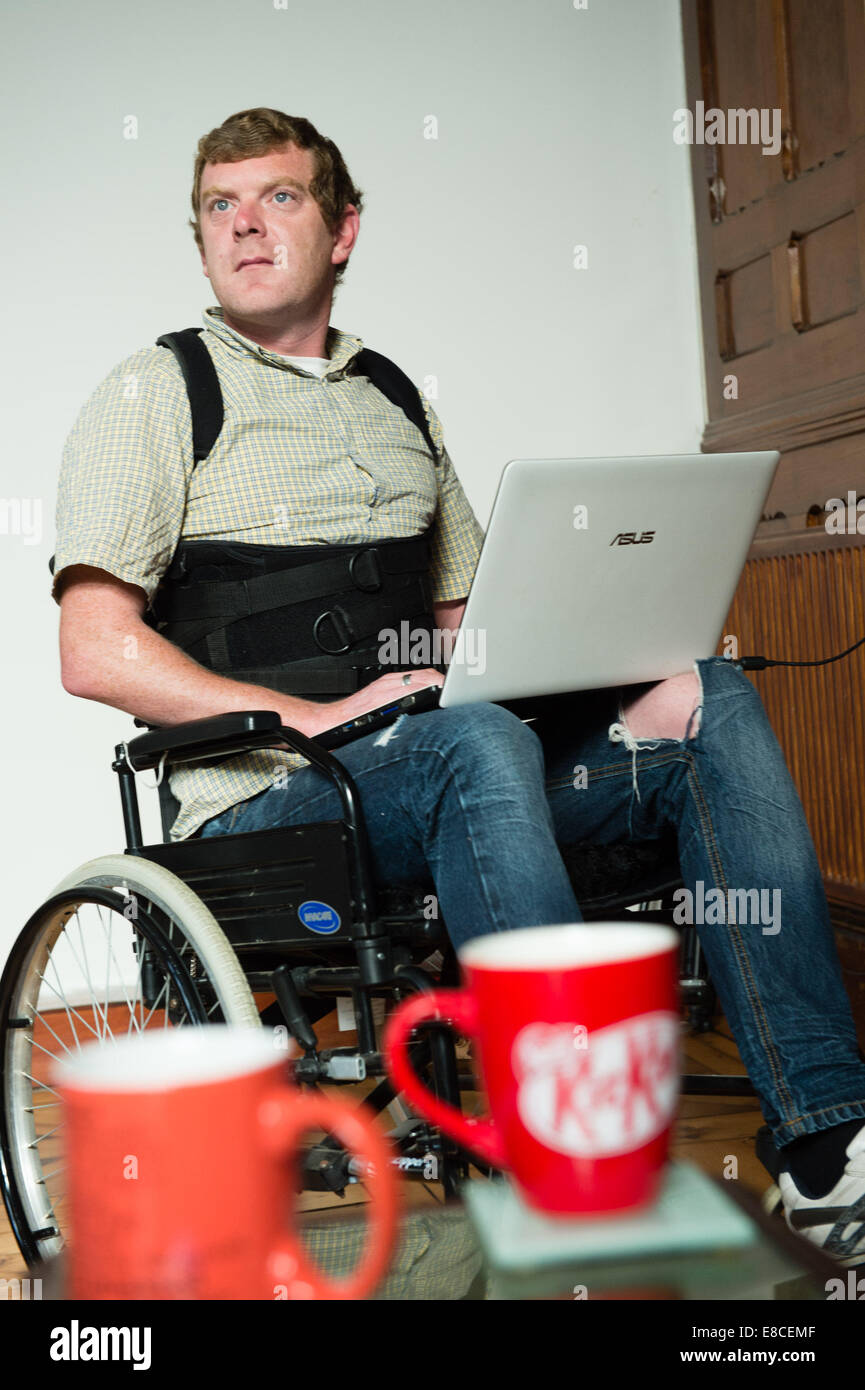 Aberystwyth, Wales, UK. 4th October, 2014. MIKE PETKOVIC, hospital radio broadcaster  and video cameraman, now confined to a wheelchair following an accident while horserideing which crushed several of his vertebra, is hoping to raise £1500 from 'crowd funding' to help pay for an electric wheelchair.  photo Credit: Keith Morris / Alamy Live News Stock Photo