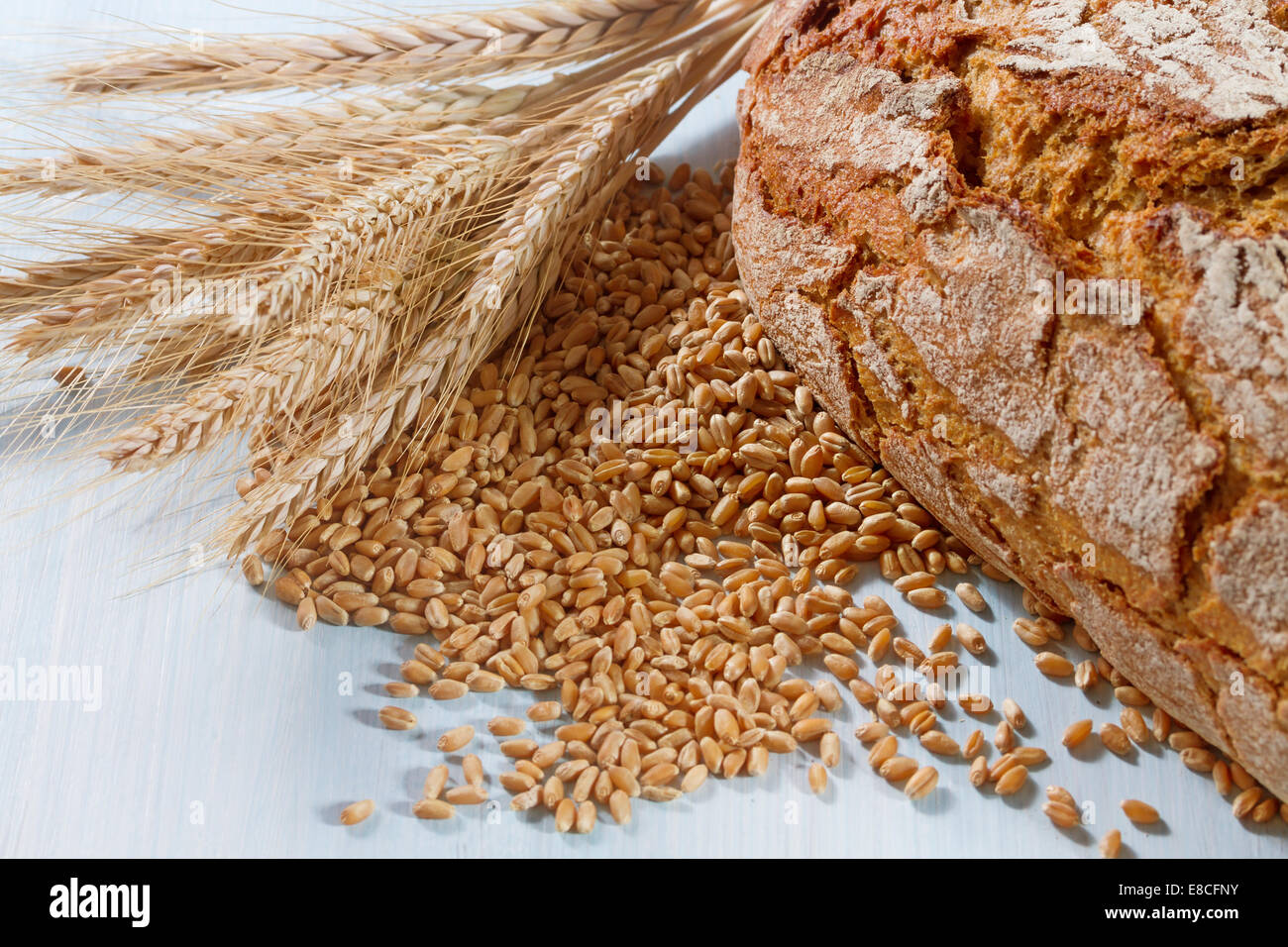 Fresh bread with wheat on the wooden background Stock Photo