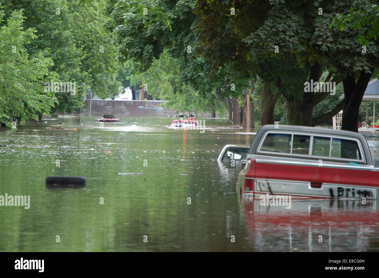 This photograph depicts flooding in Cedar Rapids, Iowa. The image captures the impact of a flood event on the city, focusing on the extent of water damage and the environmental consequences of the flood in the urban area. Stock Photo