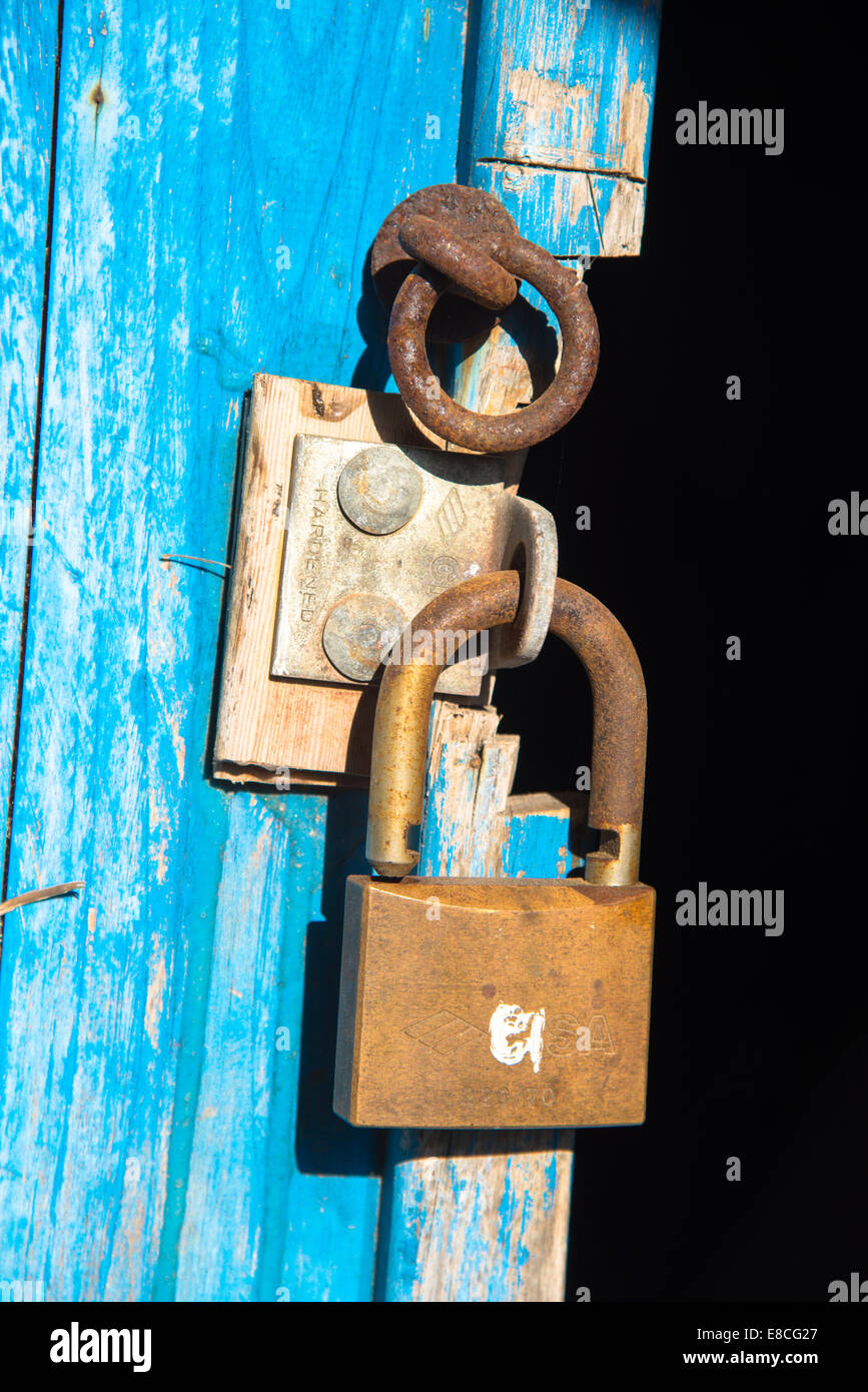 Blue old rusty unlocked padlock on wooden door Stock Photo - Alamy
