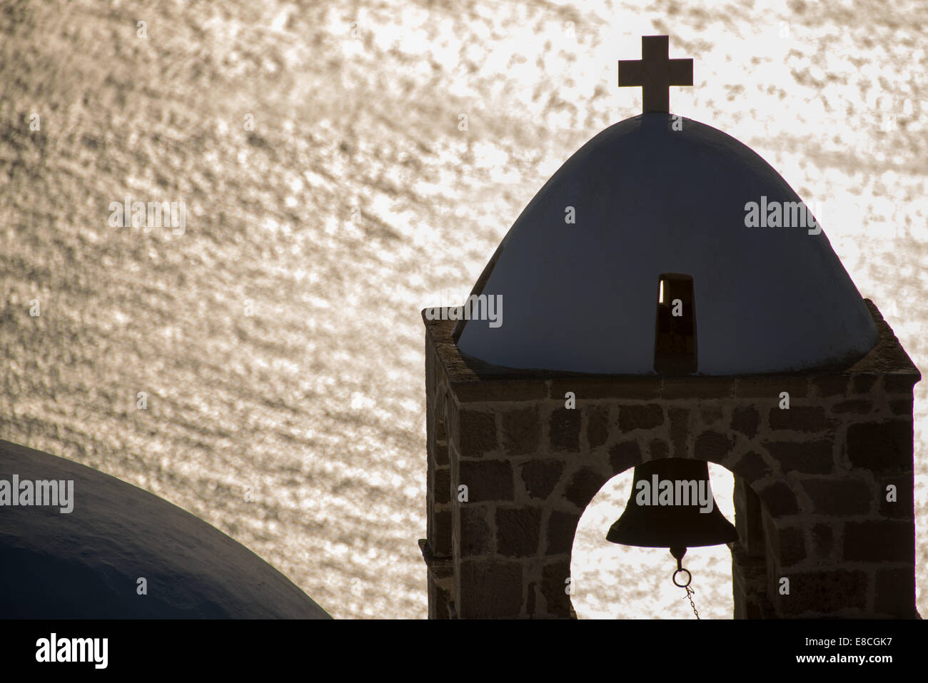 silhouette of belltower and reflection in sea at Plaka, Milos, Greece Stock Photo